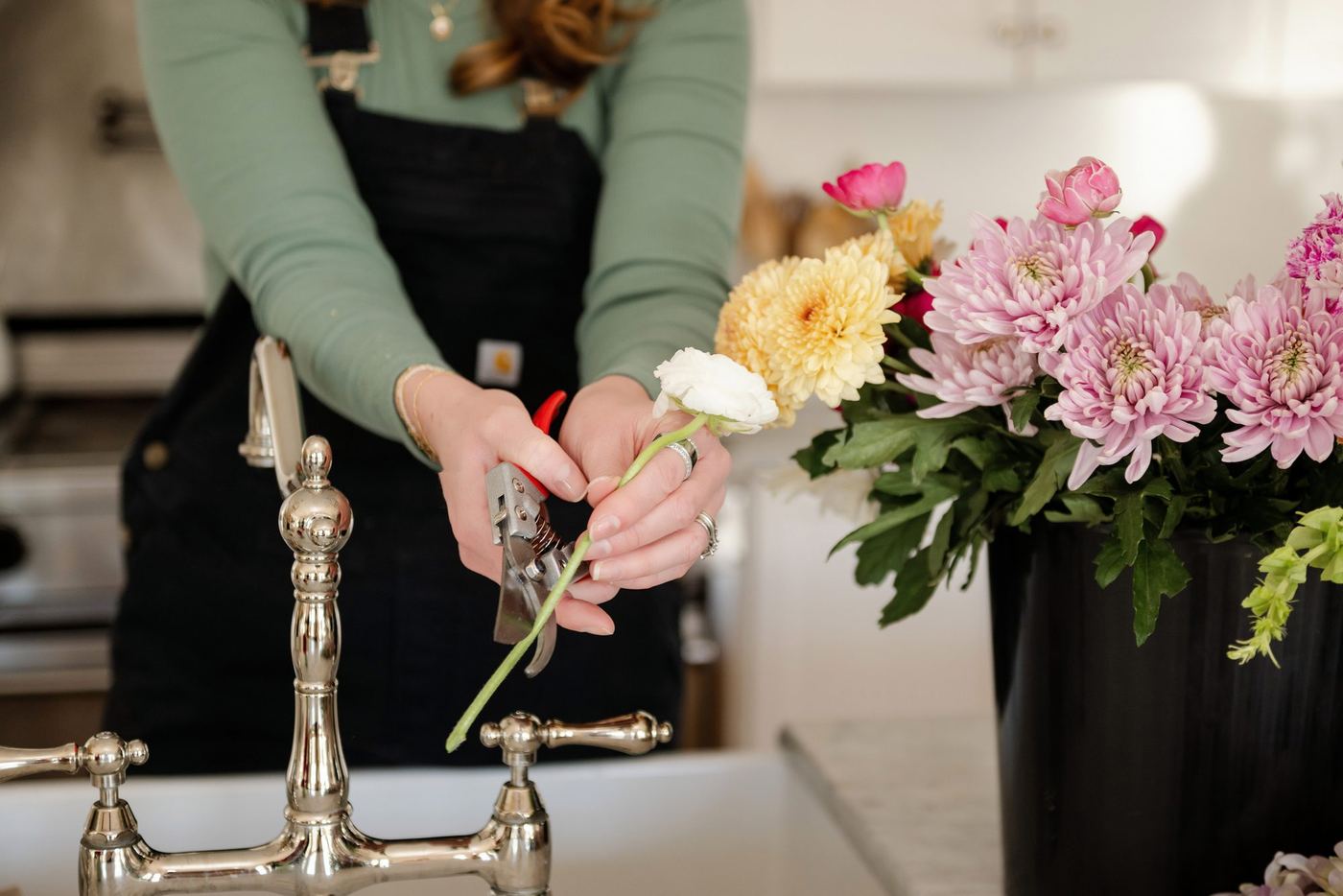 Megan trimming stems at the sink