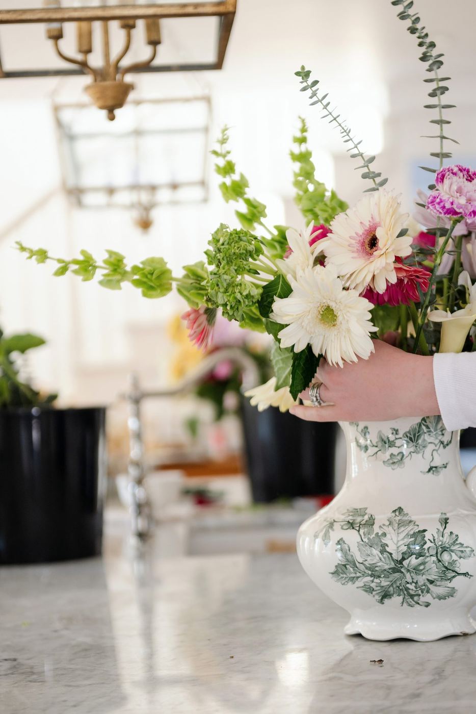 A full arrangement in a blue and white vase